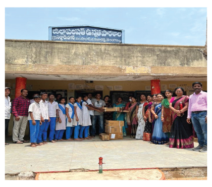 Volunteers and students outside a government school